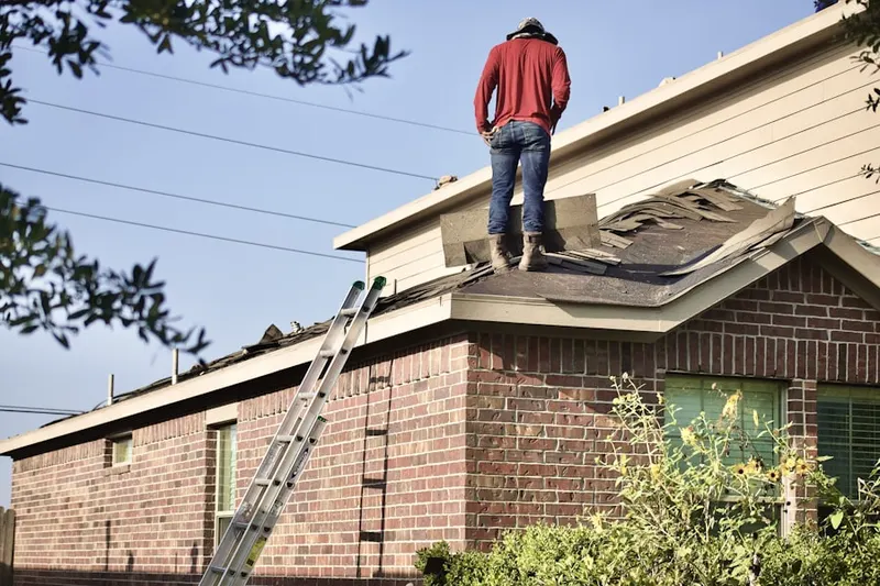 Professional roofer working on a residential roof in Centennial Park
